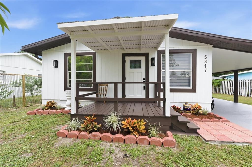 5317 Dixie Drive Naples, FL 34113 - Photo 1 of 36 a front view of a house with patio