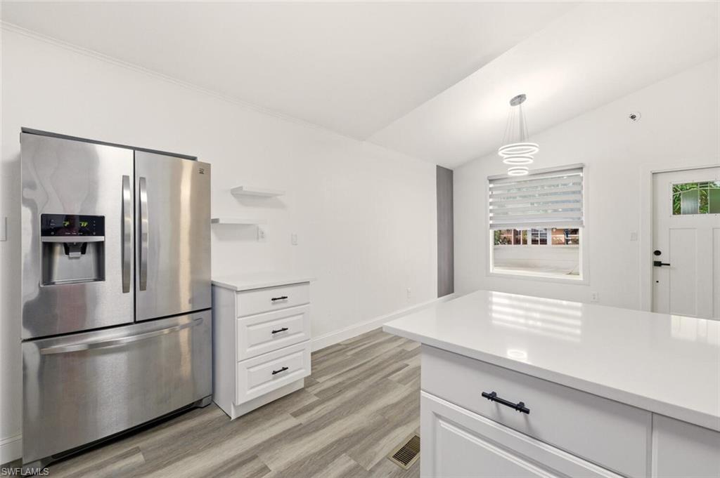 5317 Dixie Drive Naples, FL 34113 - Photo 14 of 36 a kitchen with stainless steel appliances a refrigerator and cabinets