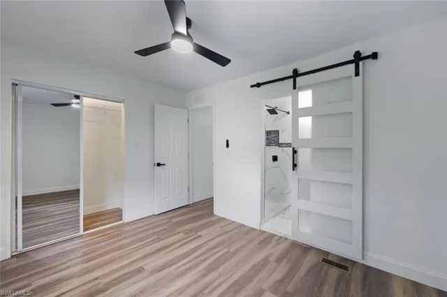 a view of empty room with wooden floor