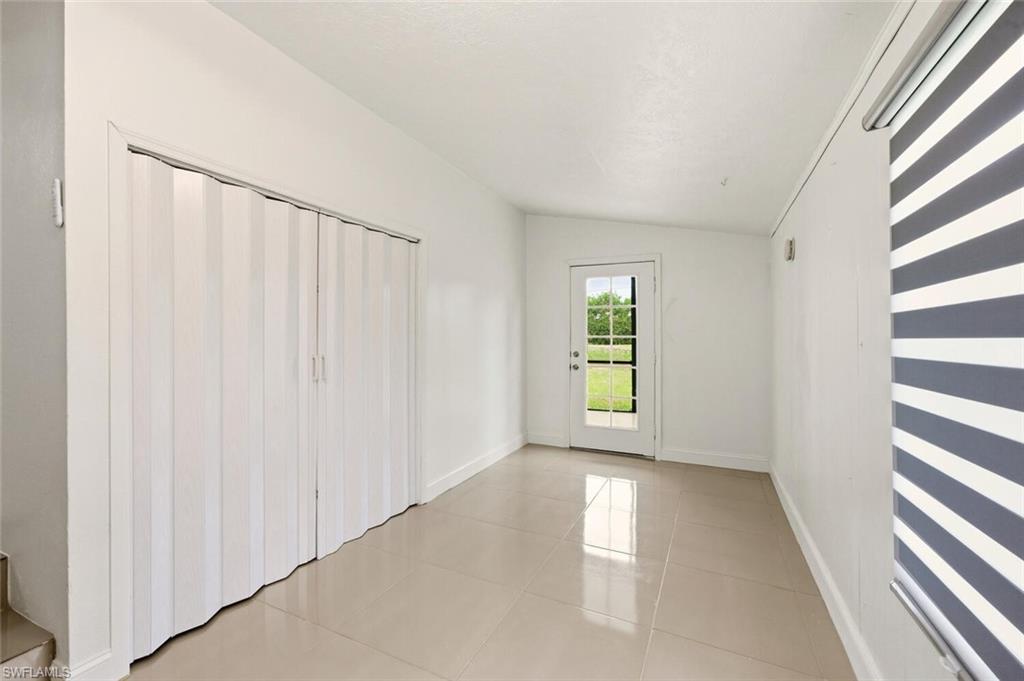 5317 Dixie Drive Naples, FL 34113 - Photo 24 of 36 wooden floor in an empty room with a window