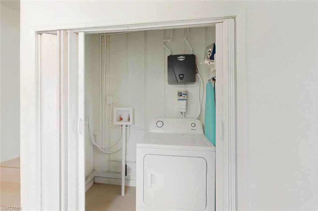 5317 Dixie Drive Naples, FL 34113 - Photo 26 of 36 a utility room with dryer and washer