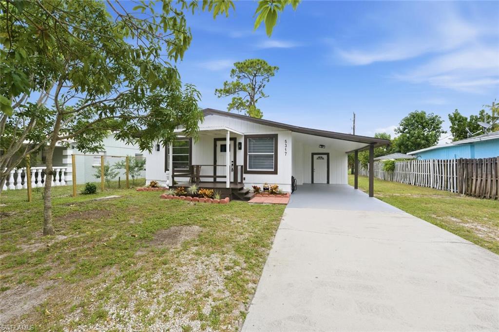 5317 Dixie Drive Naples, FL 34113 - Photo 3 of 36 a view of a house with backyard and a tree