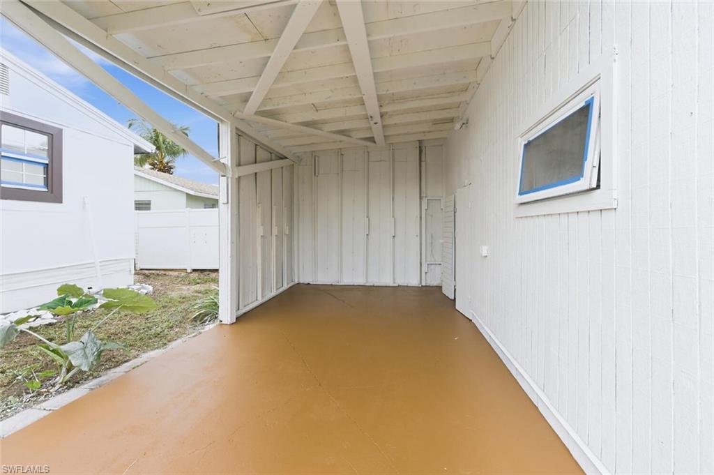 5317 Dixie Drive Naples, FL 34113 - Photo 30 of 36 a view of a hallway with a chandelier