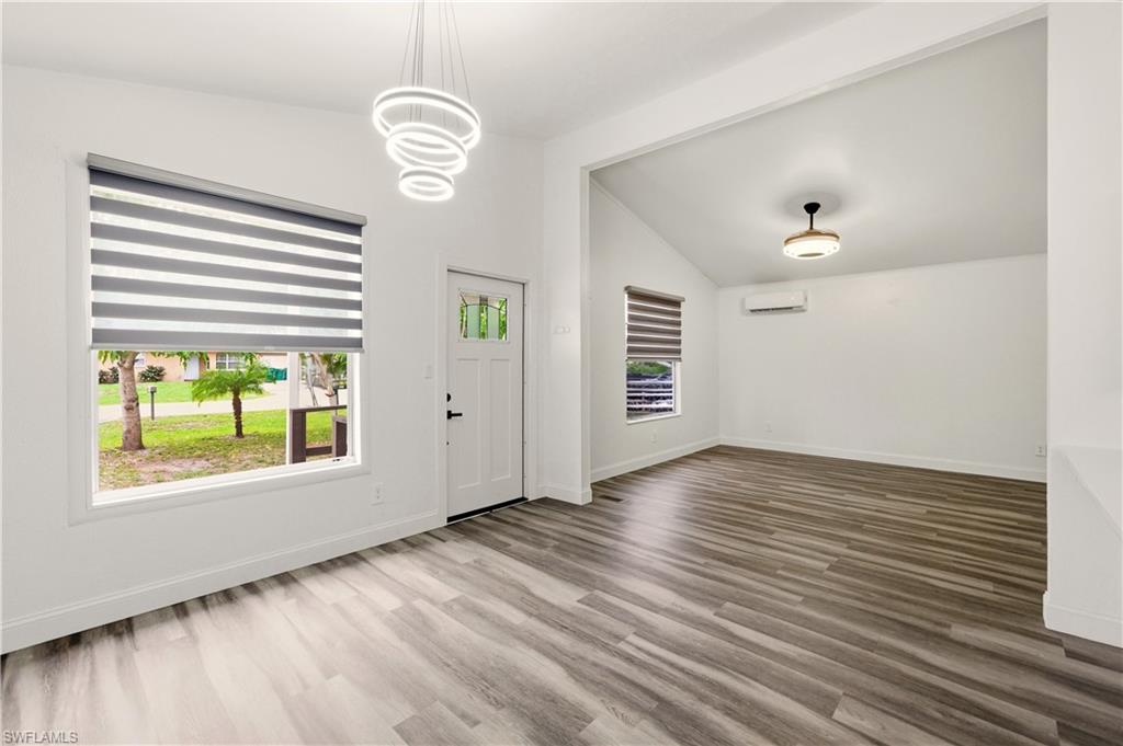 5317 Dixie Drive Naples, FL 34113 - Photo 4 of 36 a view of an empty room with wooden floor and a window