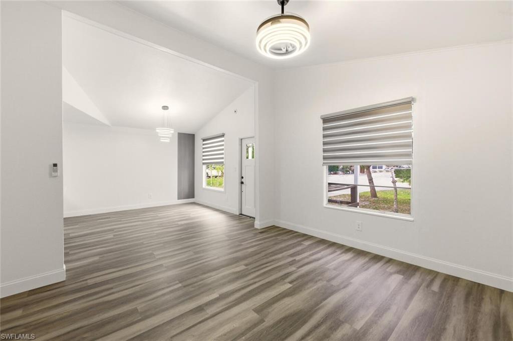 5317 Dixie Drive Naples, FL 34113 - Photo 8 of 36 an empty room with wooden floor and windows