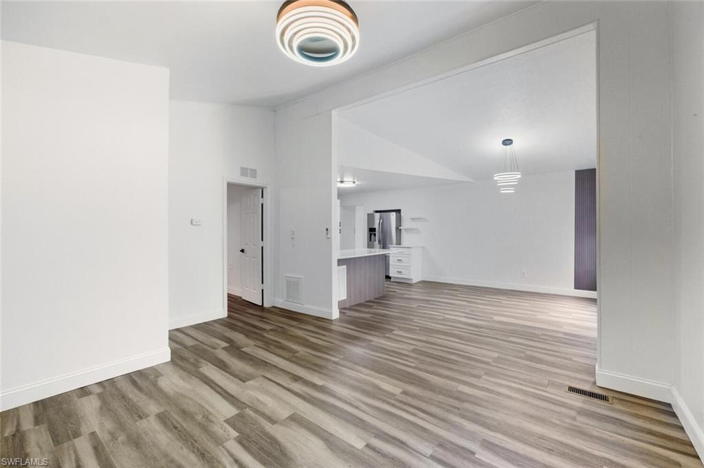 5317 Dixie Drive Naples, FL 34113 - Photo 9 of 36 a view of empty room with wooden floor