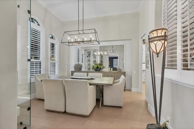 a dining room with wooden floor and chandelier