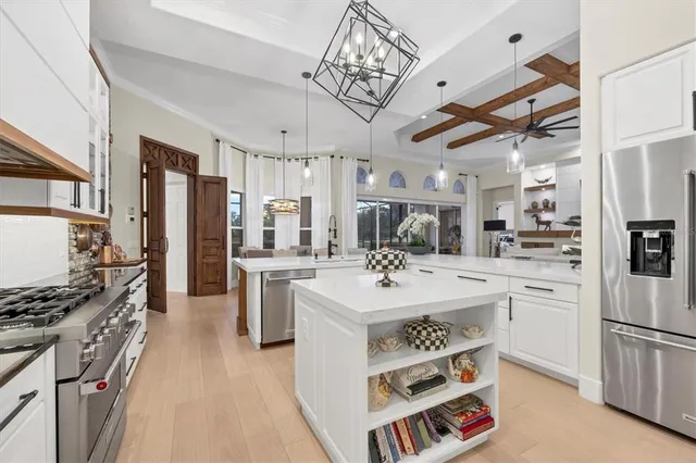a large kitchen with a table and chairs