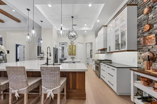 a living room with furniture a chandelier and a large window
