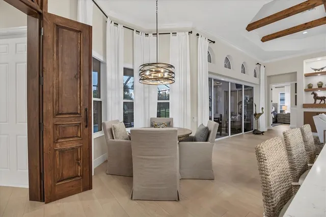 a view of a dining room with furniture and chandelier