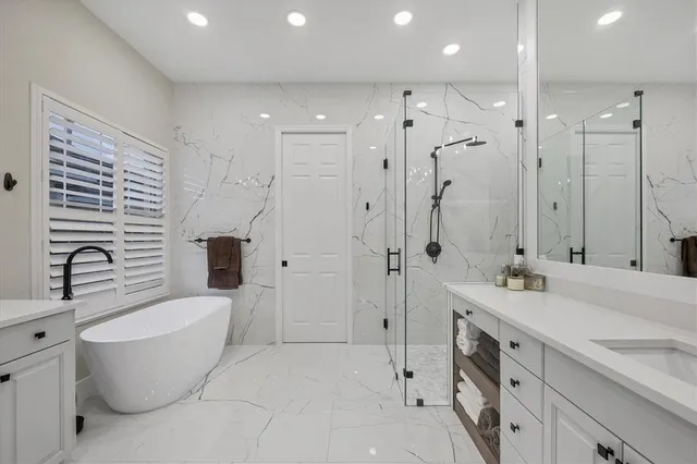 a bathroom with a shower sink and mirror