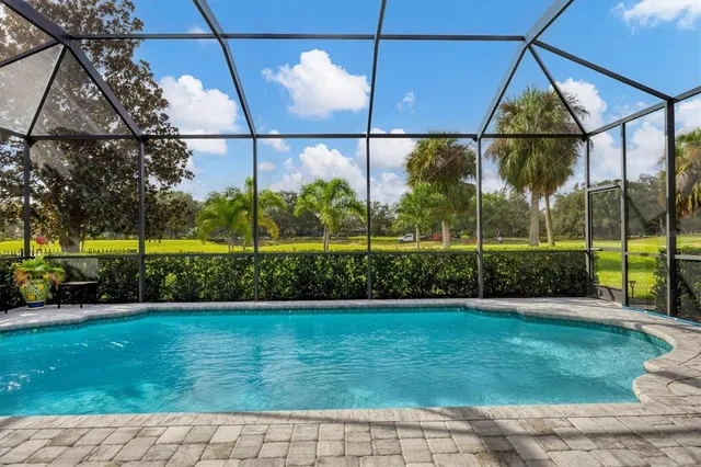 a living room with furniture and large windows