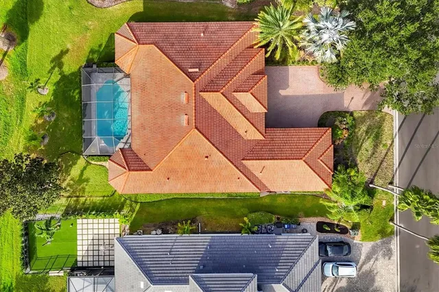 an aerial view of a city with lots of residential buildings lake and mountain view