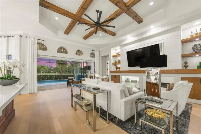 a view of a livingroom with furniture a flat screen tv and a large window
