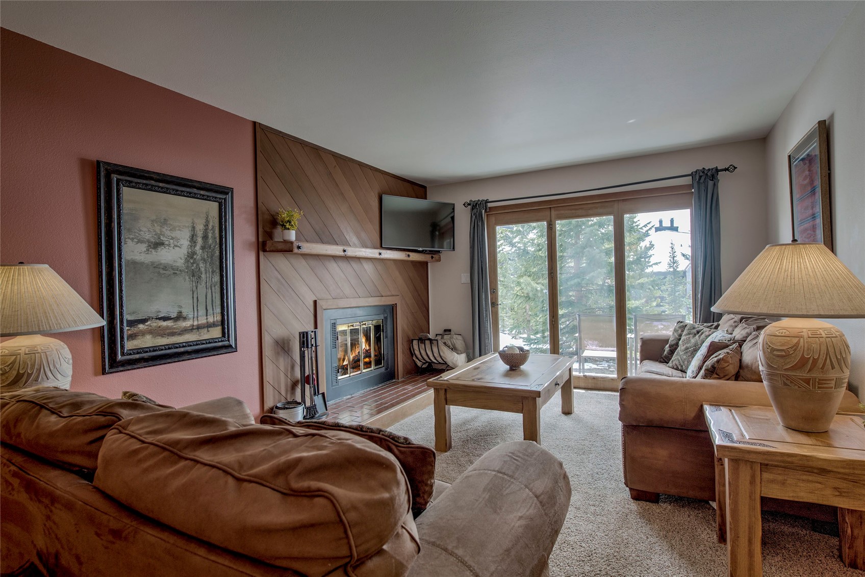 94300 Ryan Gulch Road, Unit 301 Silverthorne, CO 80498 - Photo 1 of 35 a living room with furniture and a fireplace