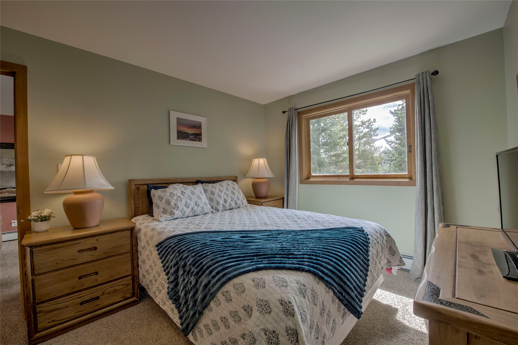 94300 Ryan Gulch Road, Unit 301 Silverthorne, CO 80498 - Photo 12 of 35 a bedroom with a bed and wooden floor