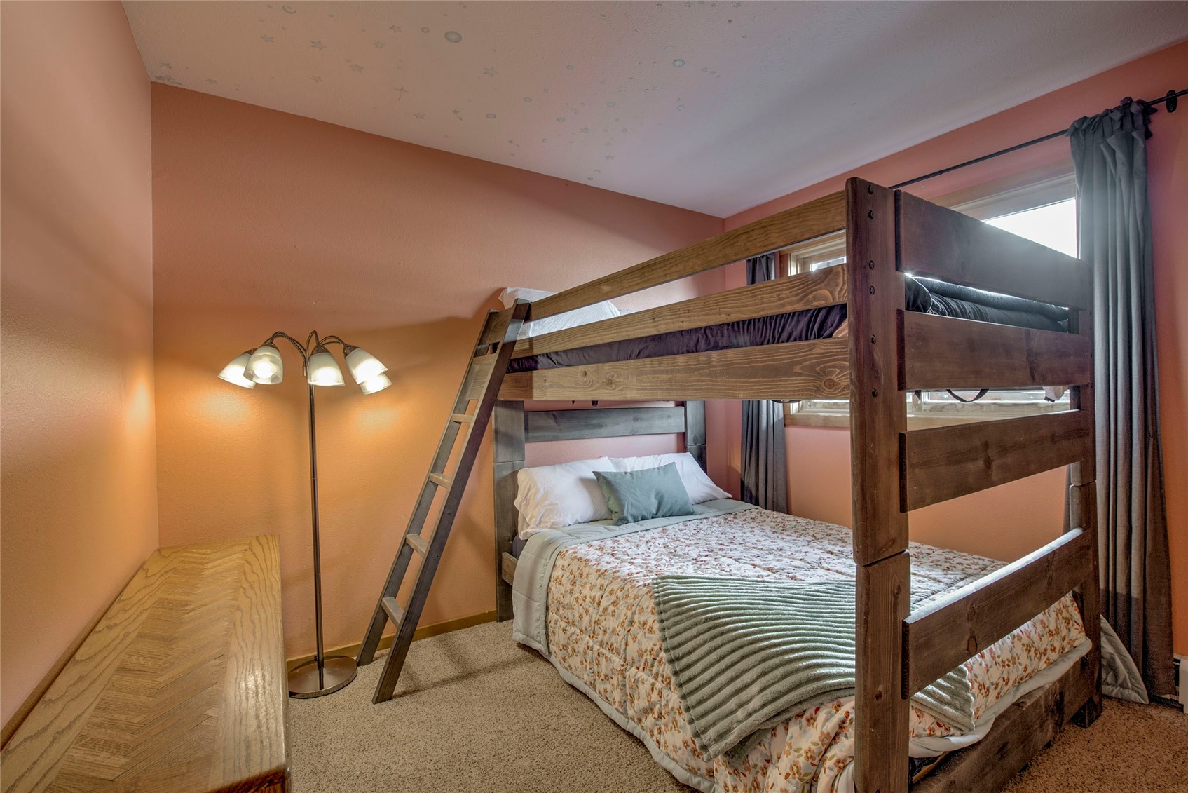 94300 Ryan Gulch Road, Unit 301 Silverthorne, CO 80498 - Photo 14 of 35 a bedroom with a bed and a mirror