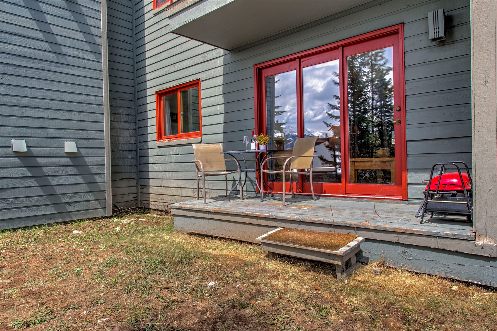 94300 Ryan Gulch Road, Unit 301 Silverthorne, CO 80498 - Photo 17 of 35 a backyard of a house with barbeque oven table and chairs