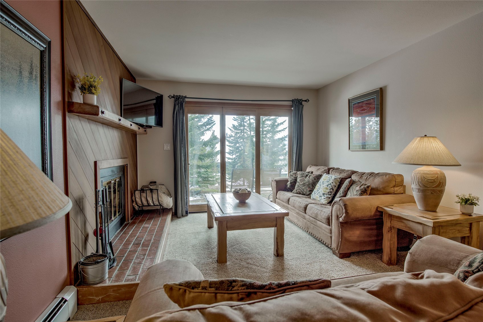 94300 Ryan Gulch Road, Unit 301 Silverthorne, CO 80498 - Photo 2 of 35 a living room with furniture and a floor to ceiling window