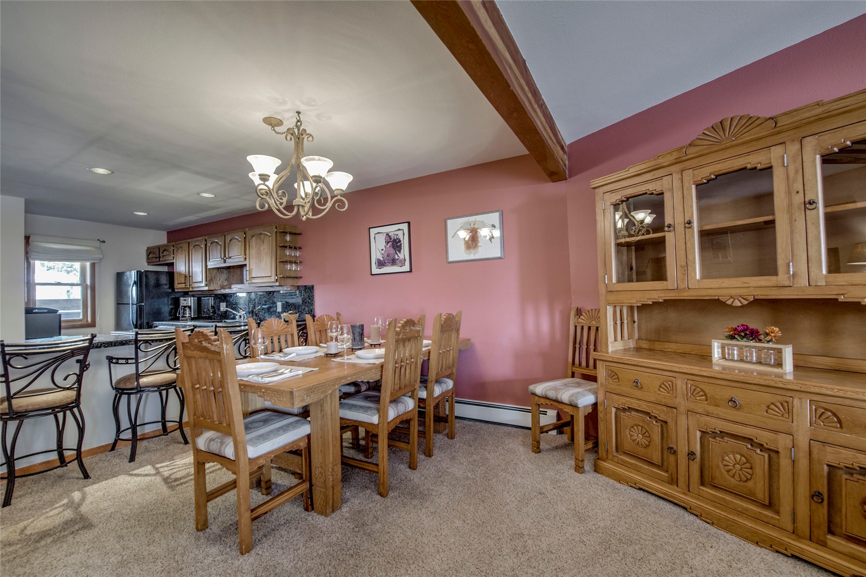 94300 Ryan Gulch Road, Unit 301 Silverthorne, CO 80498 - Photo 5 of 35 a view of a dining room with furniture and chandelier