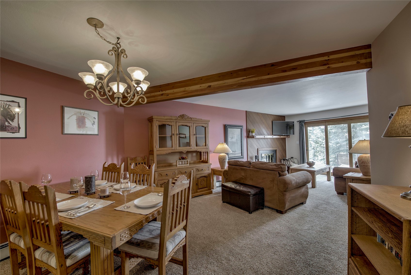94300 Ryan Gulch Road, Unit 301 Silverthorne, CO 80498 - Photo 7 of 35 a view of a dining room with furniture a chandelier and window