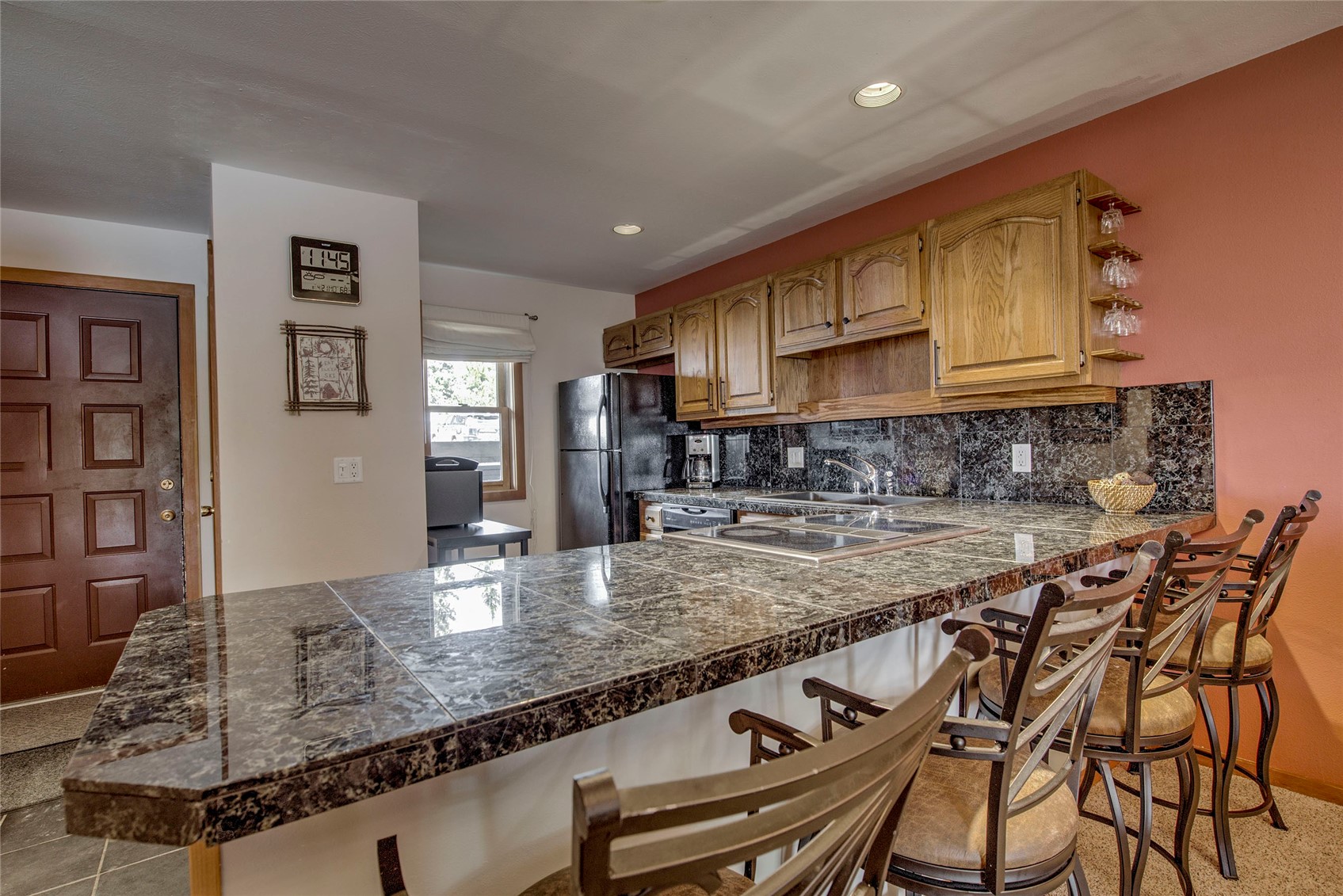 94300 Ryan Gulch Road, Unit 301 Silverthorne, CO 80498 - Photo 8 of 35 a kitchen with stainless steel appliances granite countertop a stove a sink and a refrigerator