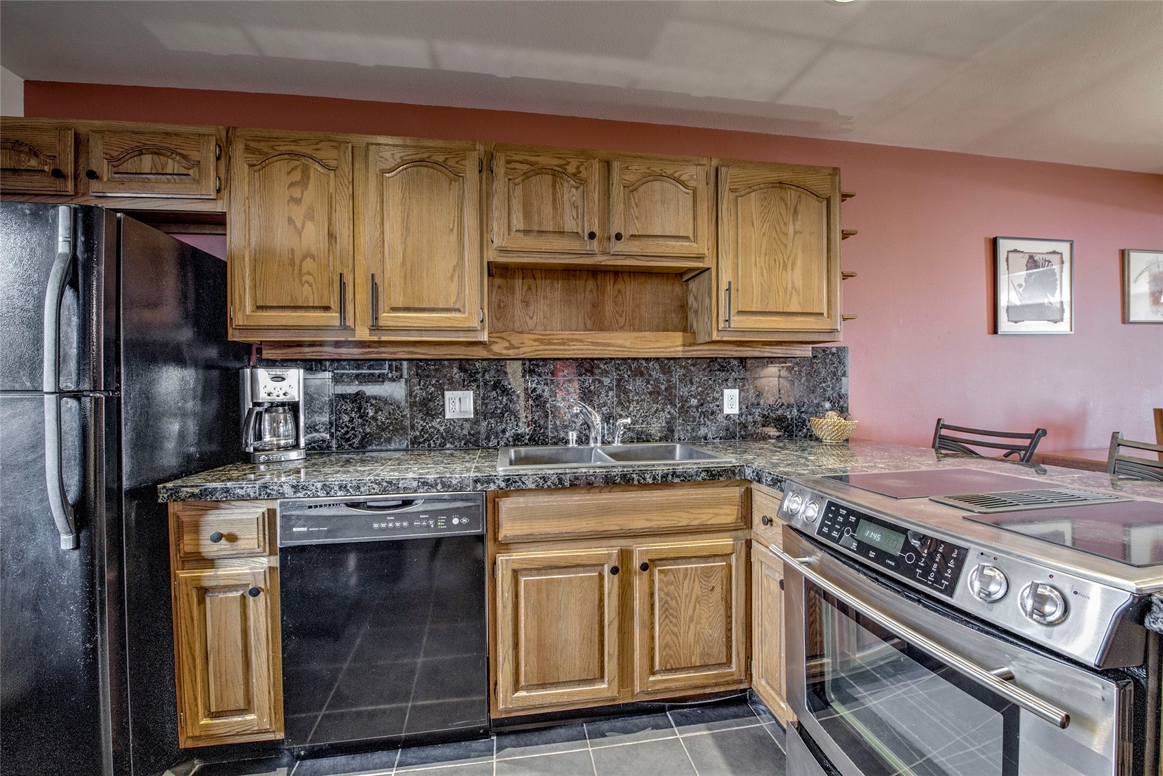 94300 Ryan Gulch Road, Unit 301 Silverthorne, CO 80498 - Photo 9 of 35 a kitchen with stainless steel appliances granite countertop a stove a sink dishwasher and cabinets