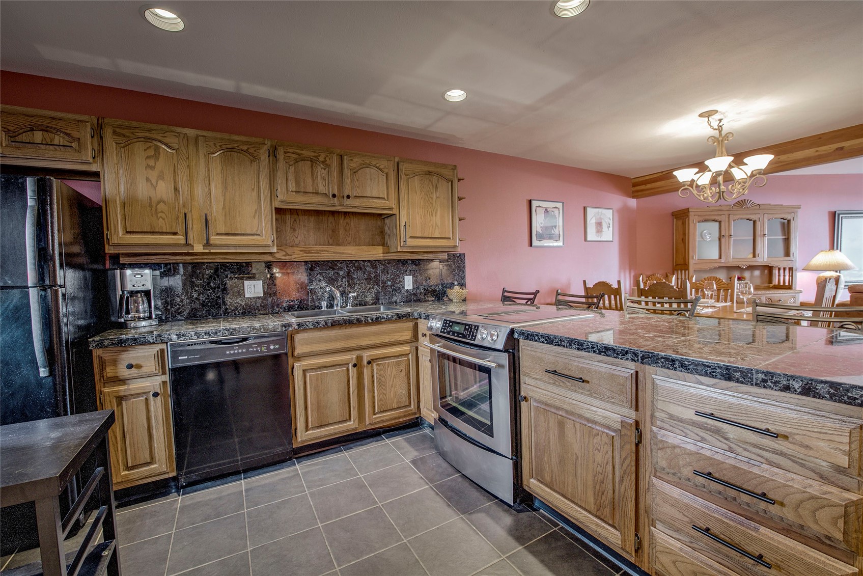 94300 Ryan Gulch Road, Unit 301 Silverthorne, CO 80498 - Photo 10 of 35 a kitchen with stainless steel appliances granite countertop a stove sink and cabinets