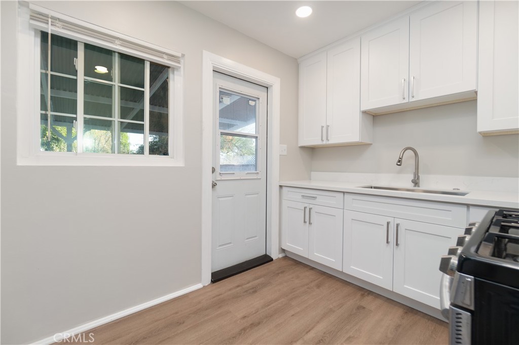 7796 Sycamore Avenue Riverside, CA 92504 - Photo 10 of 26 a kitchen with a sink cabinets and window