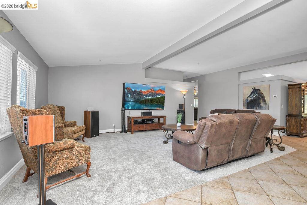 4229 Briones Valley Road Brentwood, CA 94513 - Photo 12 of 37 Living room with light tile patterned floors, light colored carpet, and vaulted ceiling with beams