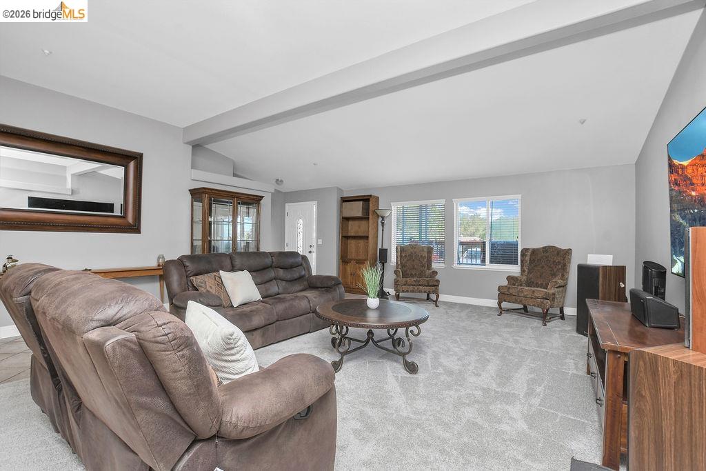 4229 Briones Valley Road Brentwood, CA 94513 - Photo 13 of 37 Living area with lofted ceiling with beams and light colored carpet