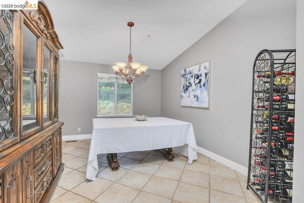 4229 Briones Valley Road Brentwood, CA 94513 - Photo 15 of 37 Dining room featuring vaulted ceiling and suspended lighting