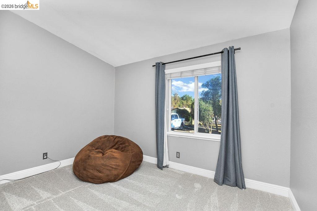 4229 Briones Valley Road Brentwood, CA 94513 - Photo 22 of 37 Living area featuring light colored carpet and vaulted ceiling