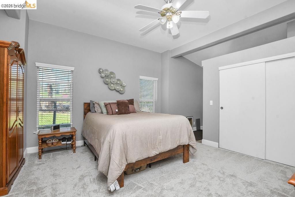 4229 Briones Valley Road Brentwood, CA 94513 - Photo 24 of 37 Bedroom with light colored carpet, ceiling fan, multiple windows, and vaulted ceiling