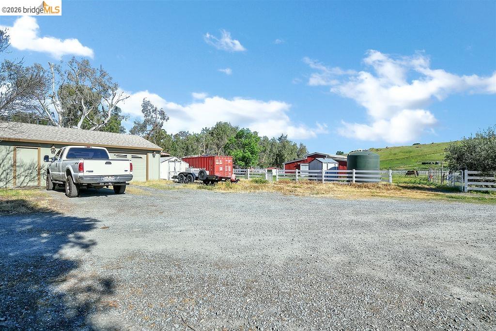 4229 Briones Valley Road Brentwood, CA 94513 - Photo 29 of 37 View of yard with an outdoor structure, driveway, and a garage