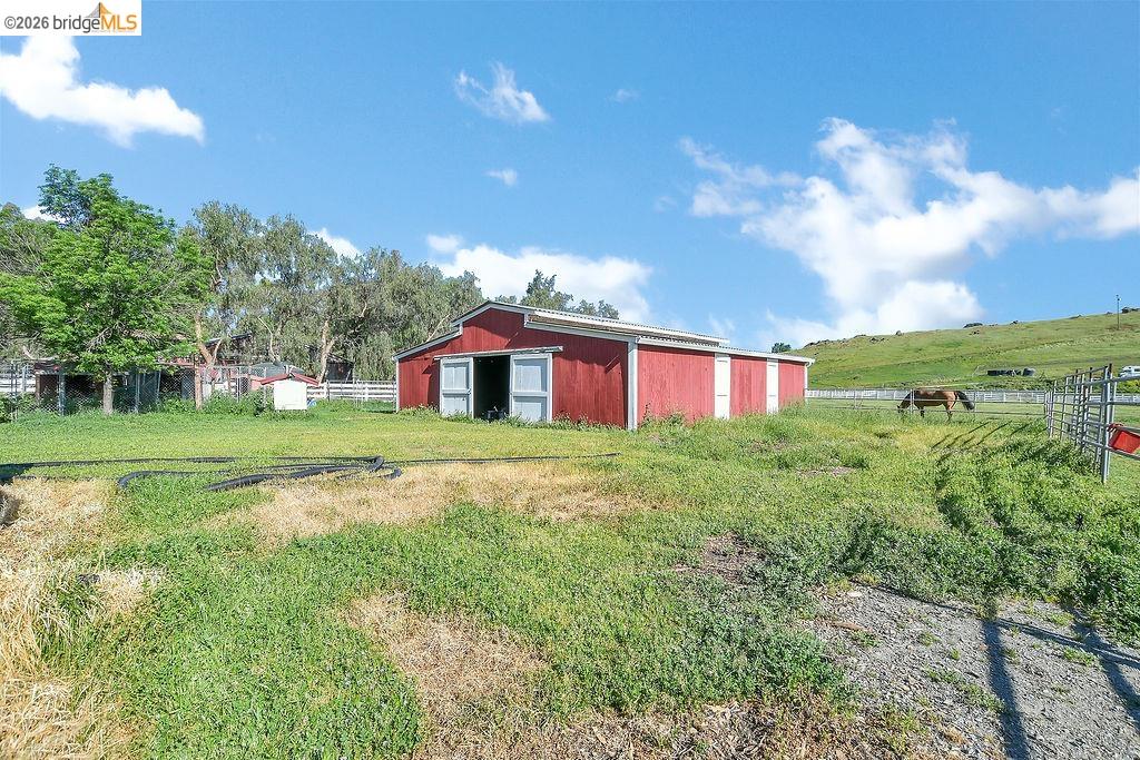 4229 Briones Valley Road Brentwood, CA 94513 - Photo 31 of 37 View of yard with an outbuilding, a garage, and a view of rural / pastoral area