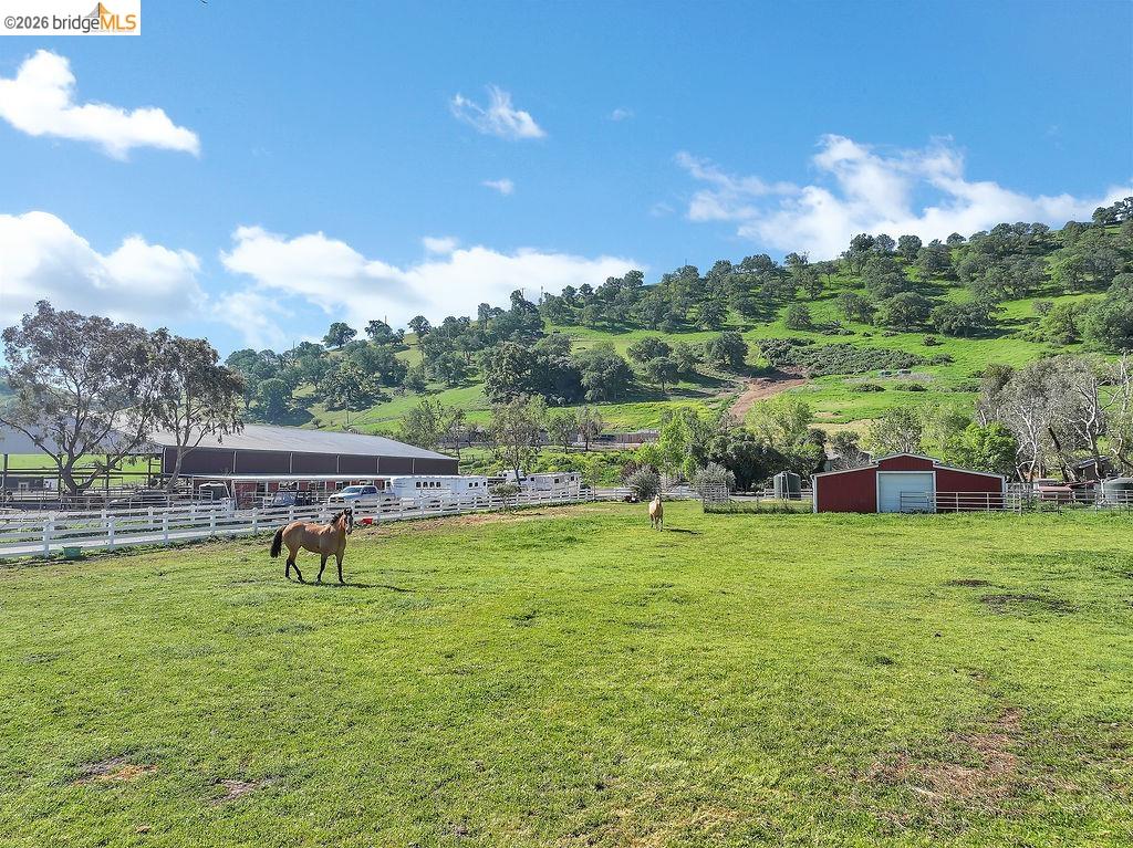 4229 Briones Valley Road Brentwood, CA 94513 - Photo 6 of 37 View of yard featuring an outbuilding, a view of countryside, an exterior structure, a detached garage, and an enclosed horse arena