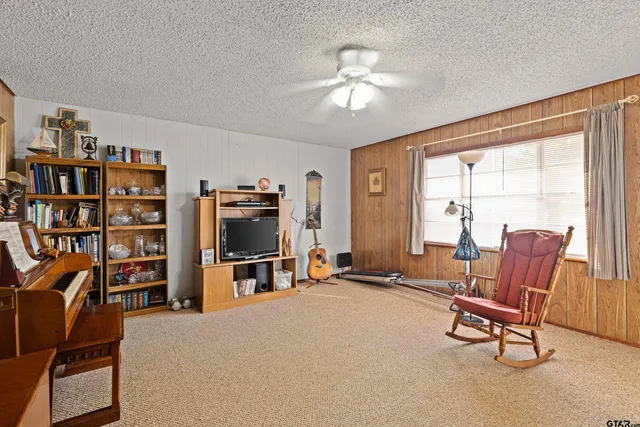 a view of a livingroom with furniture and a bookshelf