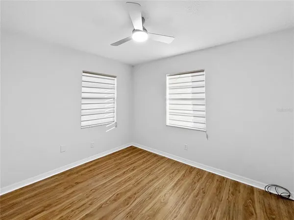 a view of a room with wooden floor and a window