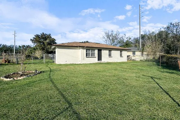 a view of a house with a yard and sitting area
