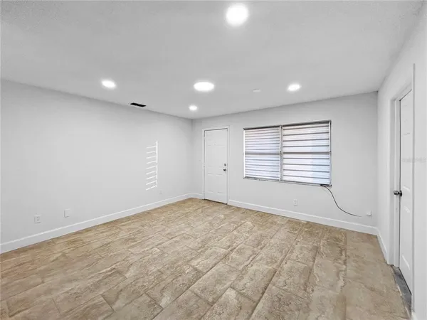 a view of an empty room with a window