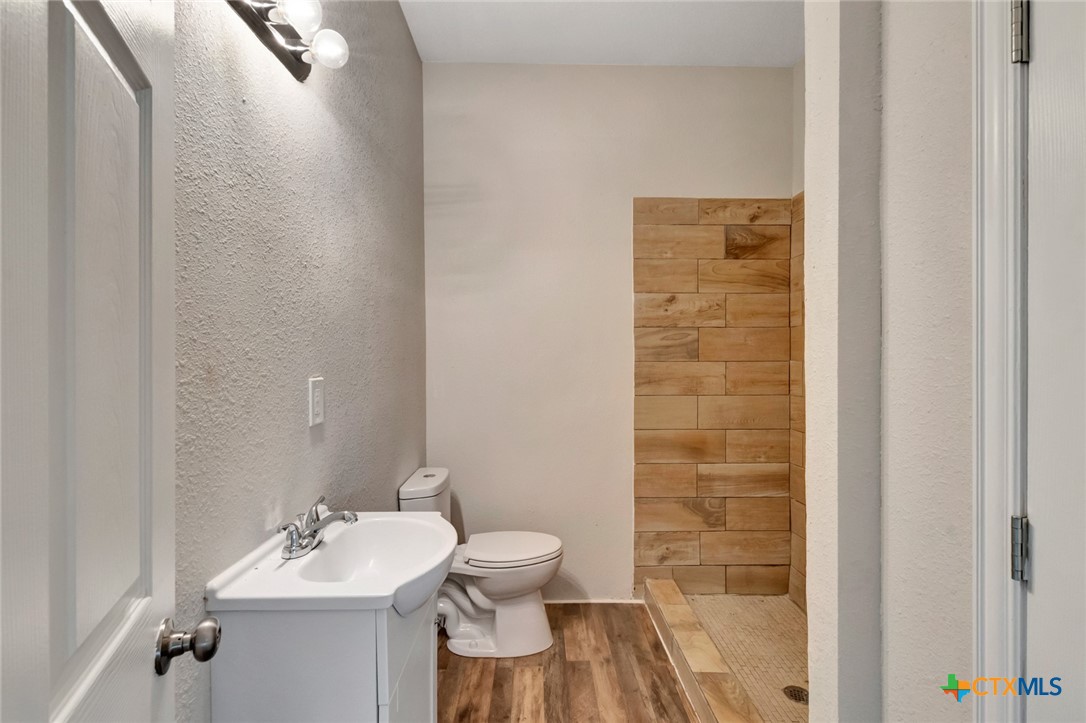 103 5th Street Seadrift, TX 77983 - Photo 15 of 18 a bathroom with a sink a toilet and shower