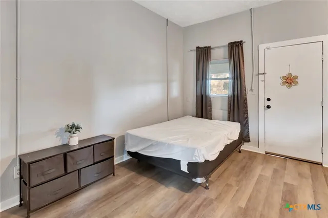 a bed room with a bed and mirror