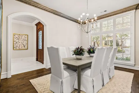 a view of a dining room with furniture and chandelier