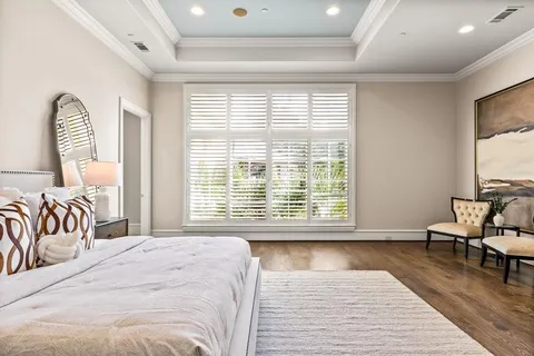 a bedroom with a bed and a large window