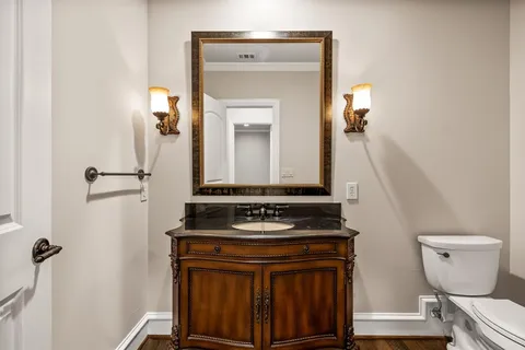 a view of bathroom with a toilet sink and mirror