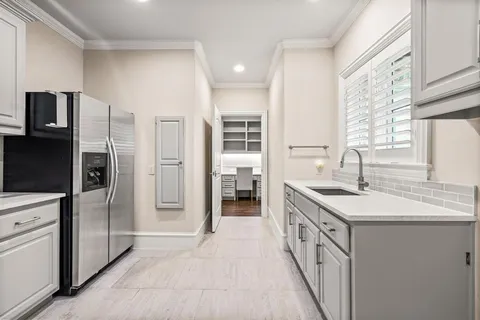a kitchen with a sink and refrigerator