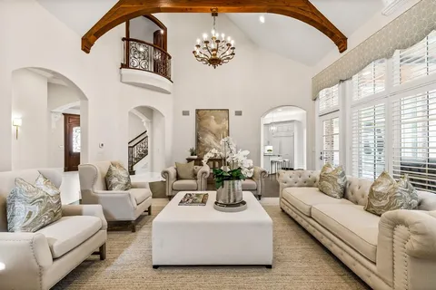 a living room with furniture and a large mirror