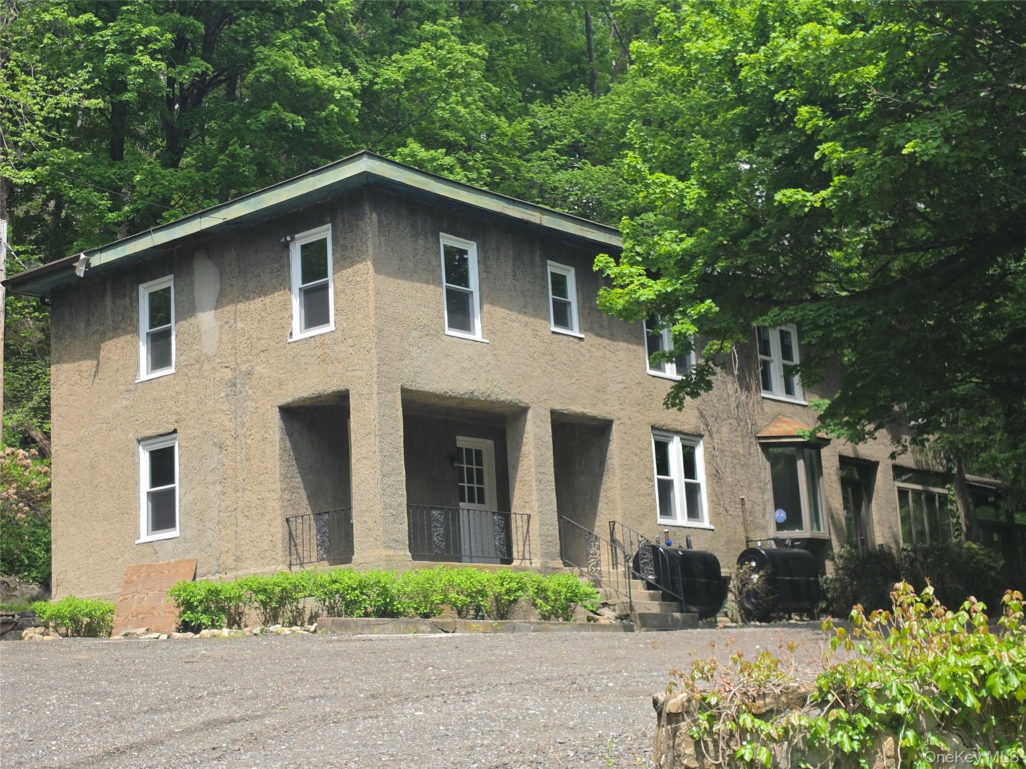 7 Stone Ridge Road Tuxedo Park, NY 10987 - Photo 1 of 33 a front view of a house with a garden
