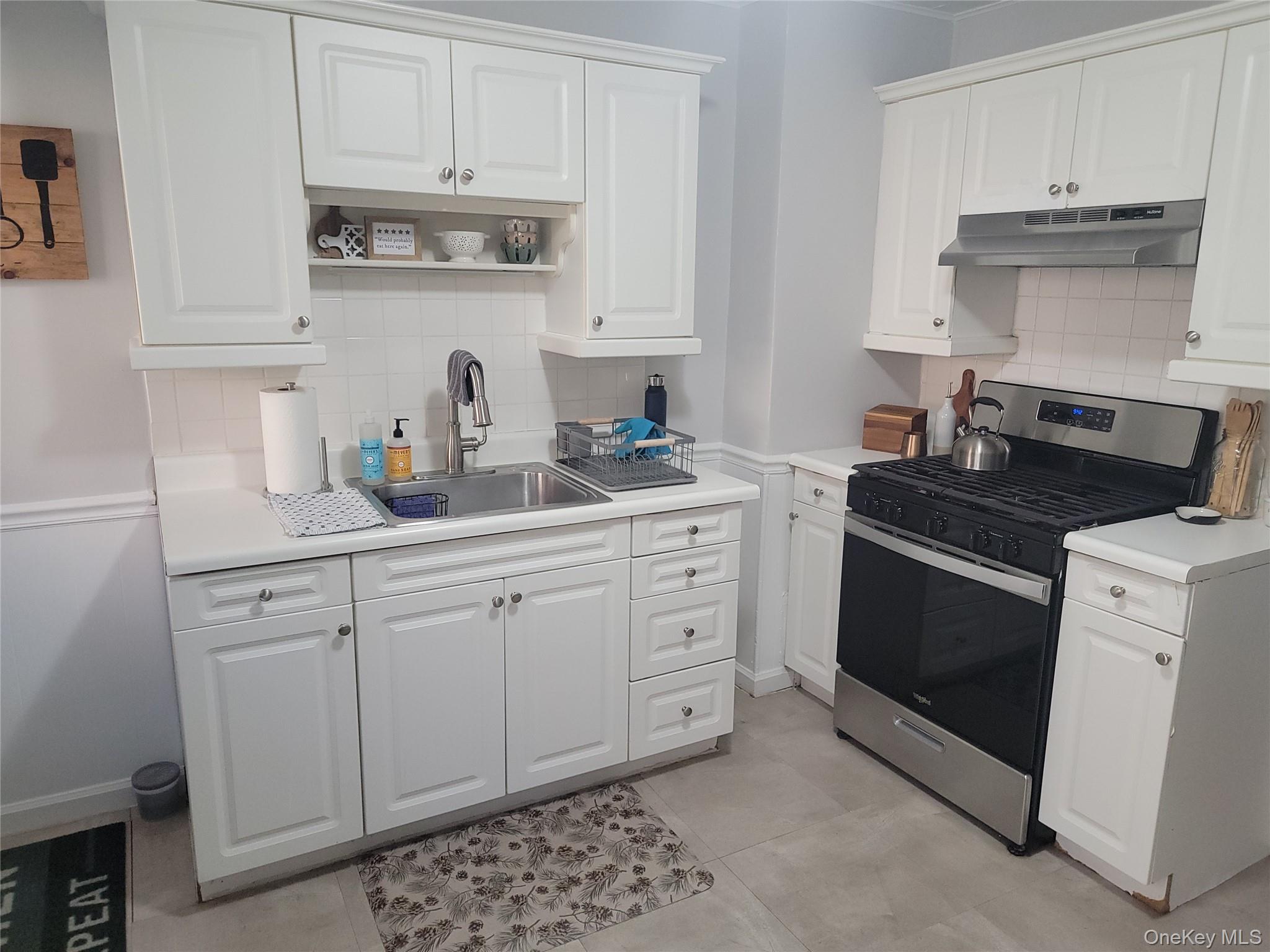 7 Stone Ridge Road Tuxedo Park, NY 10987 - Photo 11 of 33 a kitchen with white cabinets and appliances
